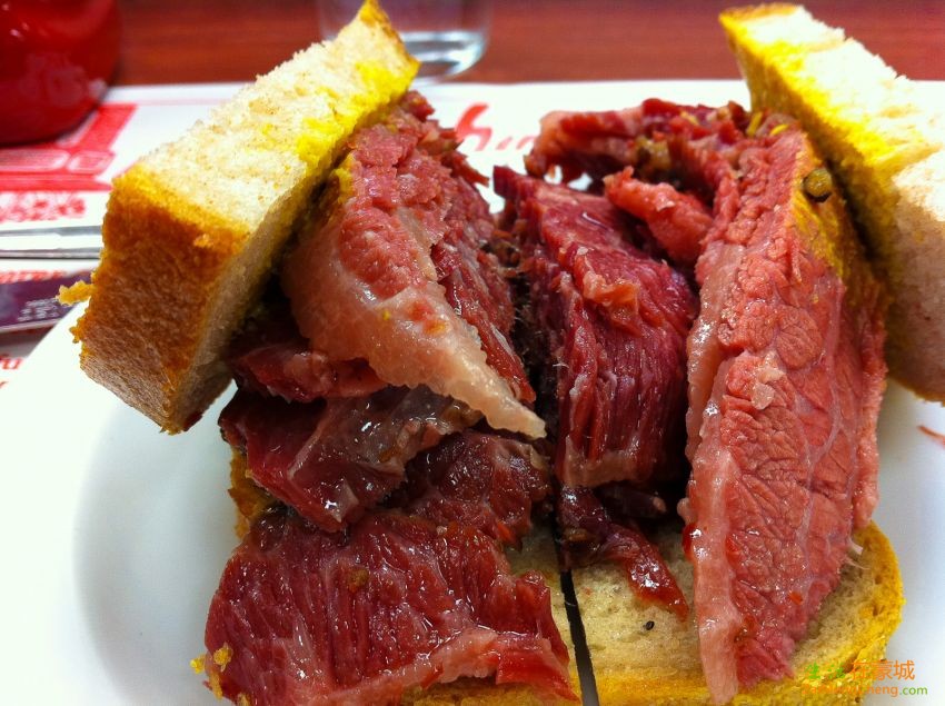 Schwartzs-Montreal-Smoked-Meat-Sandwich-Side-View.jpg
